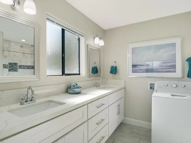 a utility room with sink dryer and washer