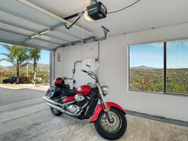a view of a patio with couches and a table and chairs with wooden fence