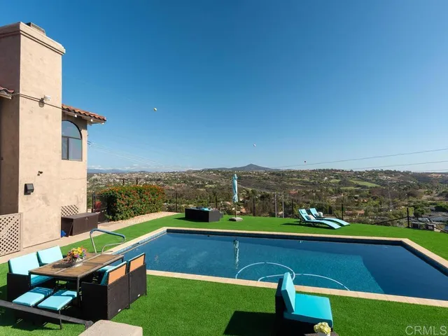 an aerial view of residential house with outdoor space and parking