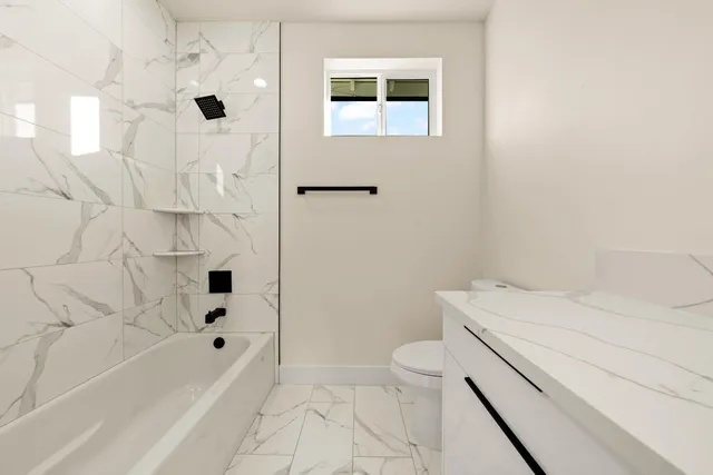 a bedroom with a bed and a night stand