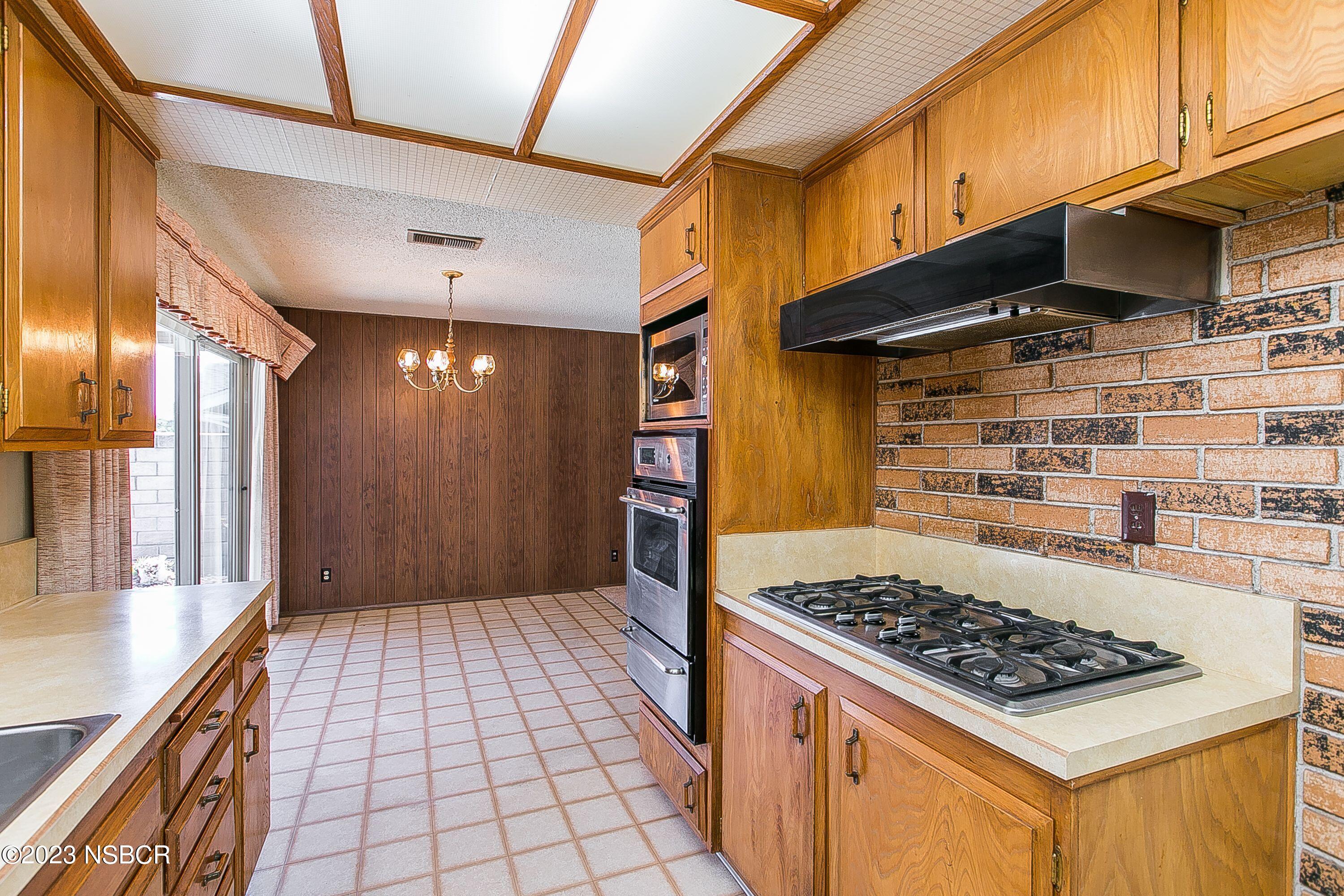 4071 Rigel Avenue Lompoc, CA 93436 - Photo 11 of 24 a kitchen with a stove and a refrigerator