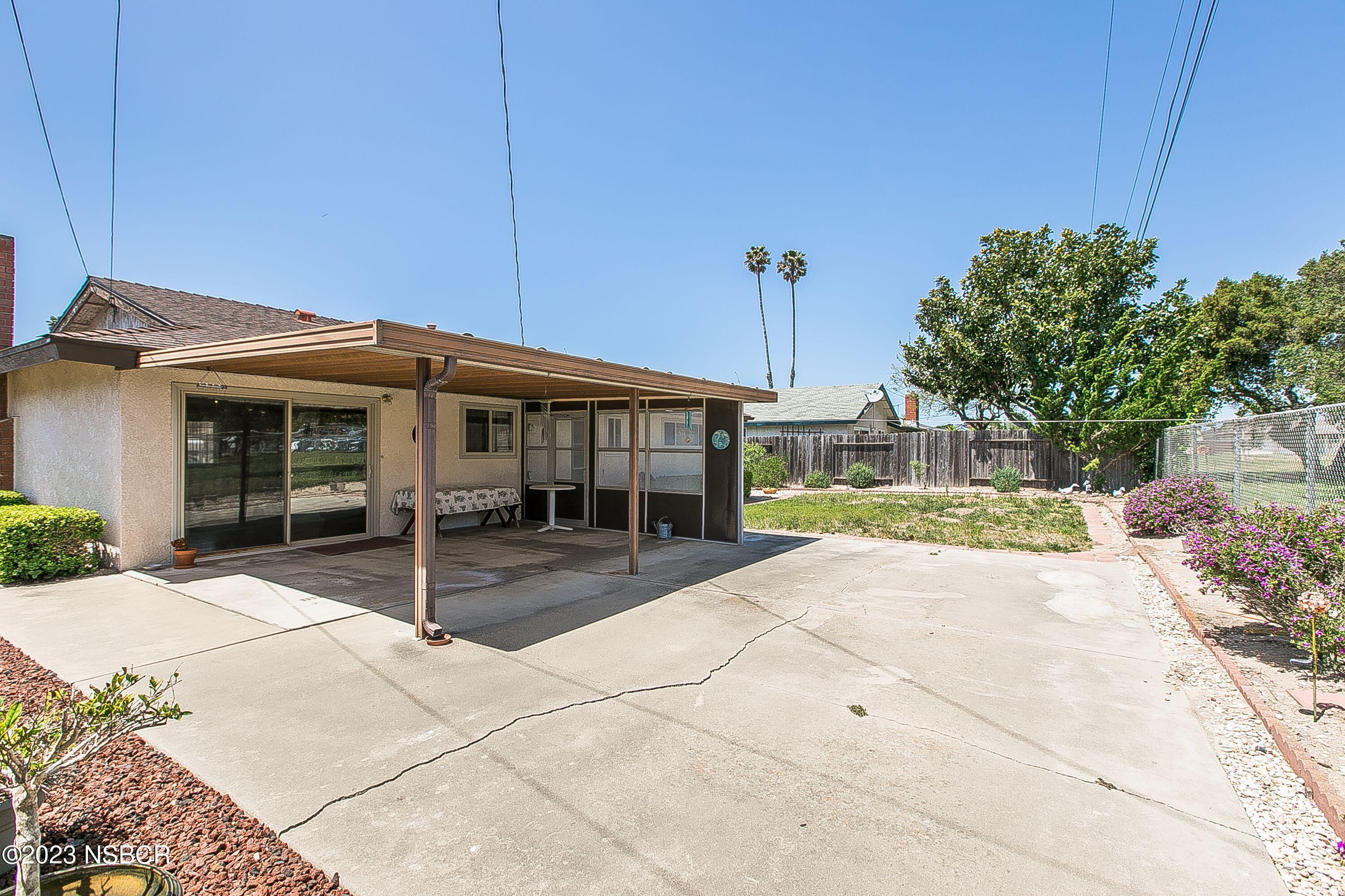 4071 Rigel Avenue Lompoc, CA 93436 - Photo 22 of 24 a view of a house with a patio and a yard