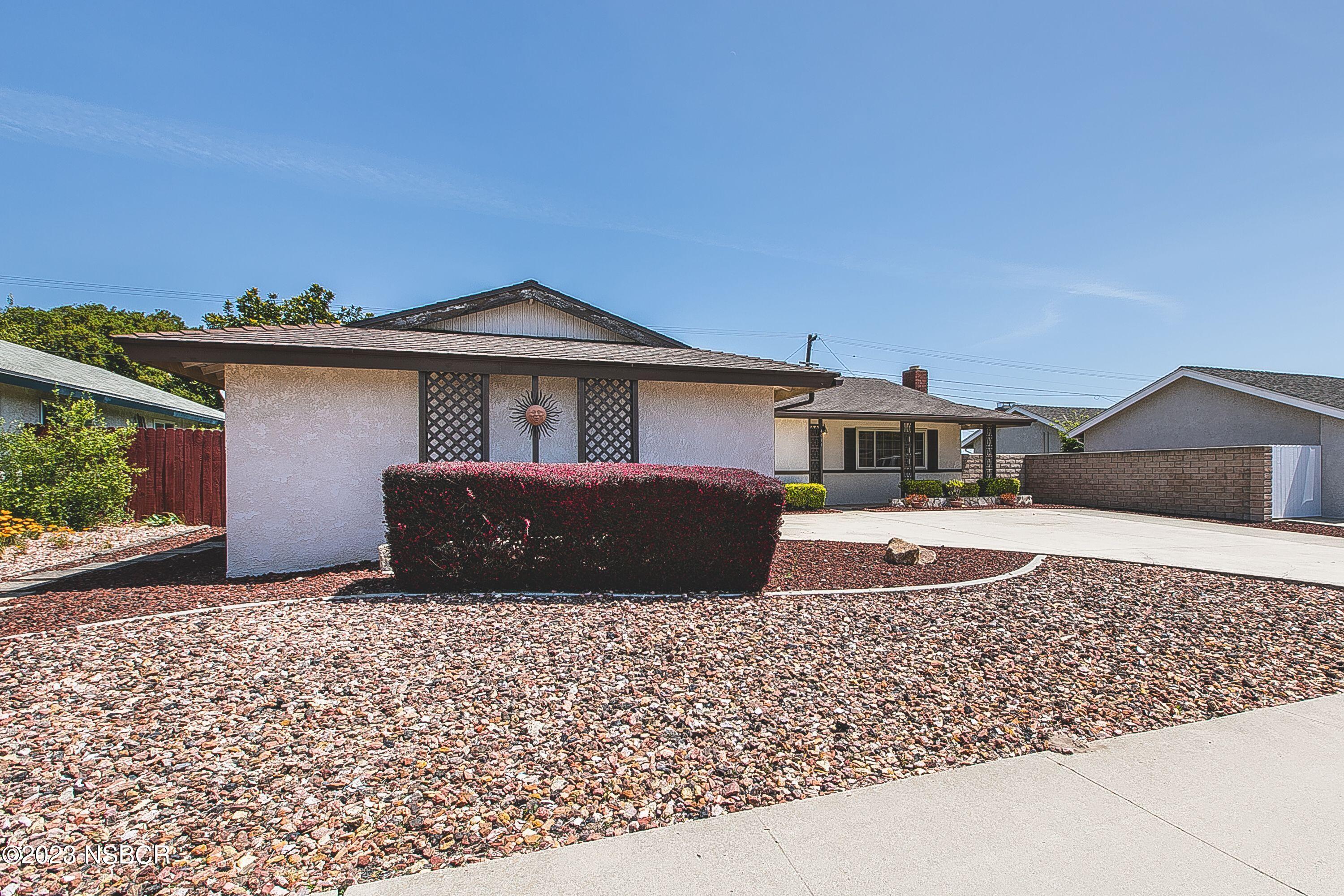 4071 Rigel Avenue Lompoc, CA 93436 - Photo 3 of 24 a front view of a house with a garden