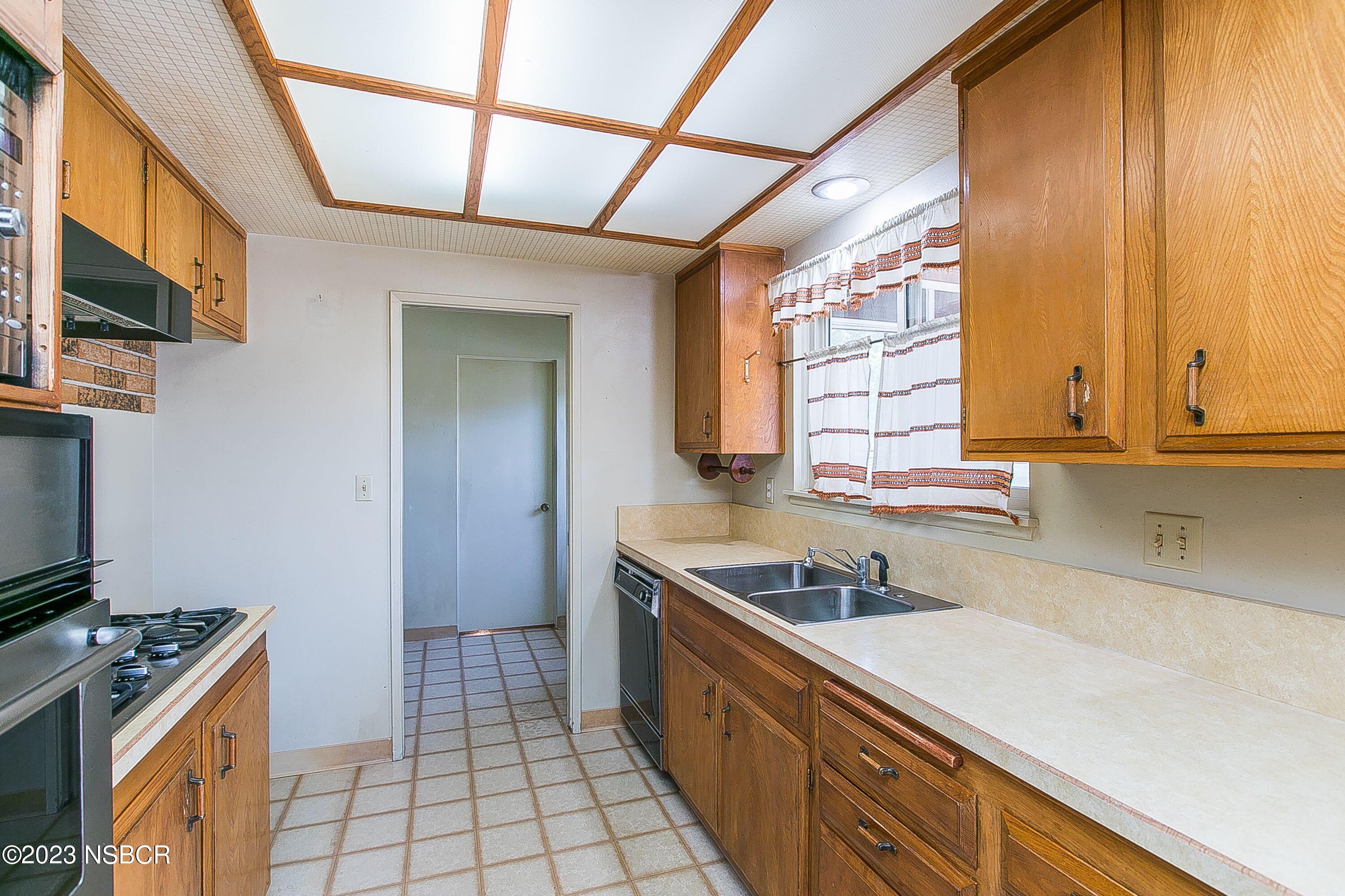 4071 Rigel Avenue Lompoc, CA 93436 - Photo 8 of 24 a kitchen with a sink and a stove