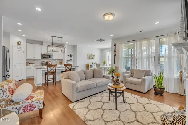a living room with furniture and kitchen view