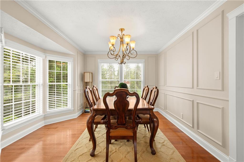 602 Birch Court Bridgeville, PA 15017 - Photo 8 of 47 a dining room with furniture a chandelier and wooden floor