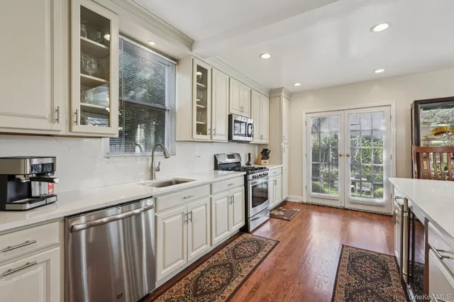 a kitchen with granite countertop a sink stove and cabinets