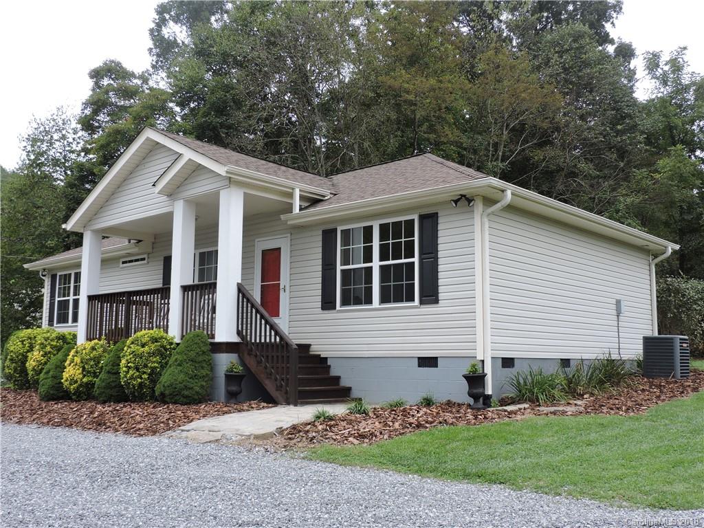 598 Lickstone Road Waynesville, NC 28786 - Photo 1 of 32 a front view of a house with a garden