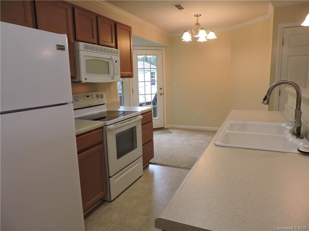 598 Lickstone Road Waynesville, NC 28786 - Photo 22 of 32 a kitchen with stainless steel appliances a refrigerator sink and stove
