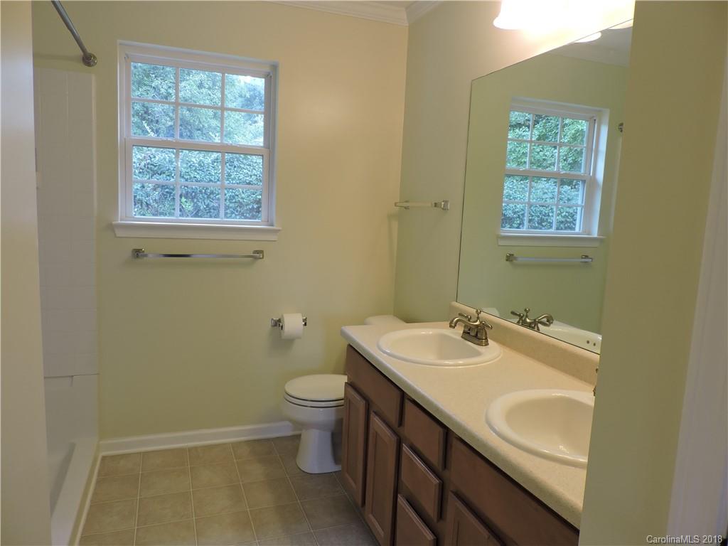 598 Lickstone Road Waynesville, NC 28786 - Photo 24 of 32 a bathroom with a toilet sink and mirror