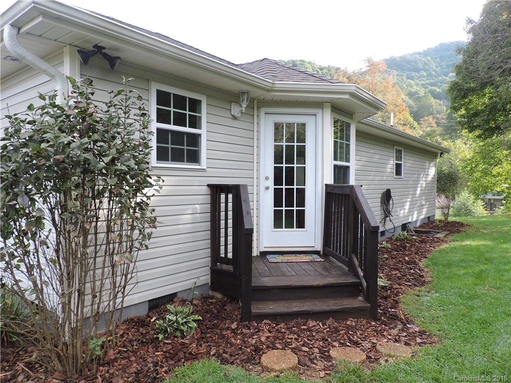 598 Lickstone Road Waynesville, NC 28786 - Photo 27 of 32 a front view of a house with garden