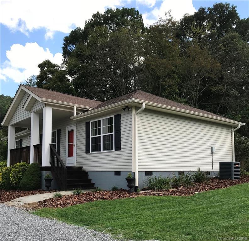 598 Lickstone Road Waynesville, NC 28786 - Photo 31 of 32 a front view of a house with a garden