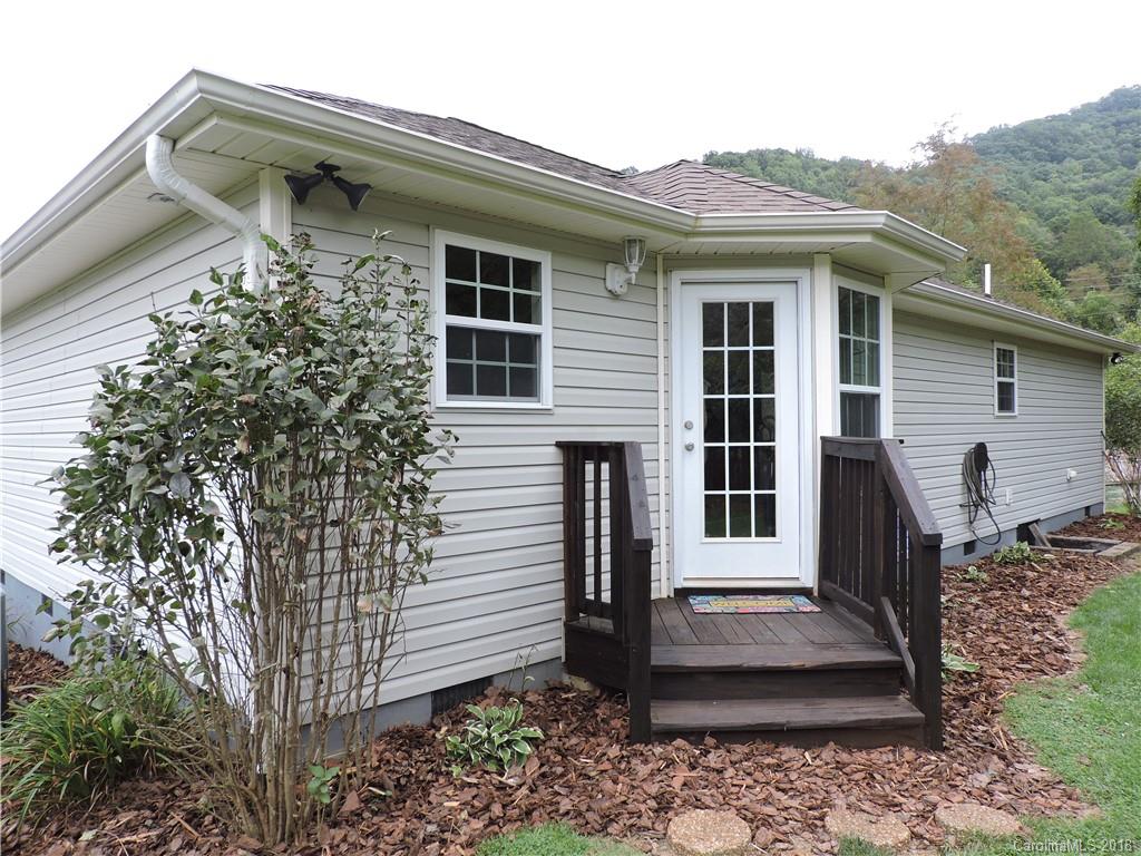 598 Lickstone Road Waynesville, NC 28786 - Photo 7 of 32 a front view of a house with garden