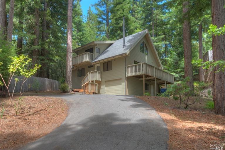 38051 Ocean Ridge Drive Gualala, CA 95445 - Photo 1 of 1 a view of a house with a yard and large tree