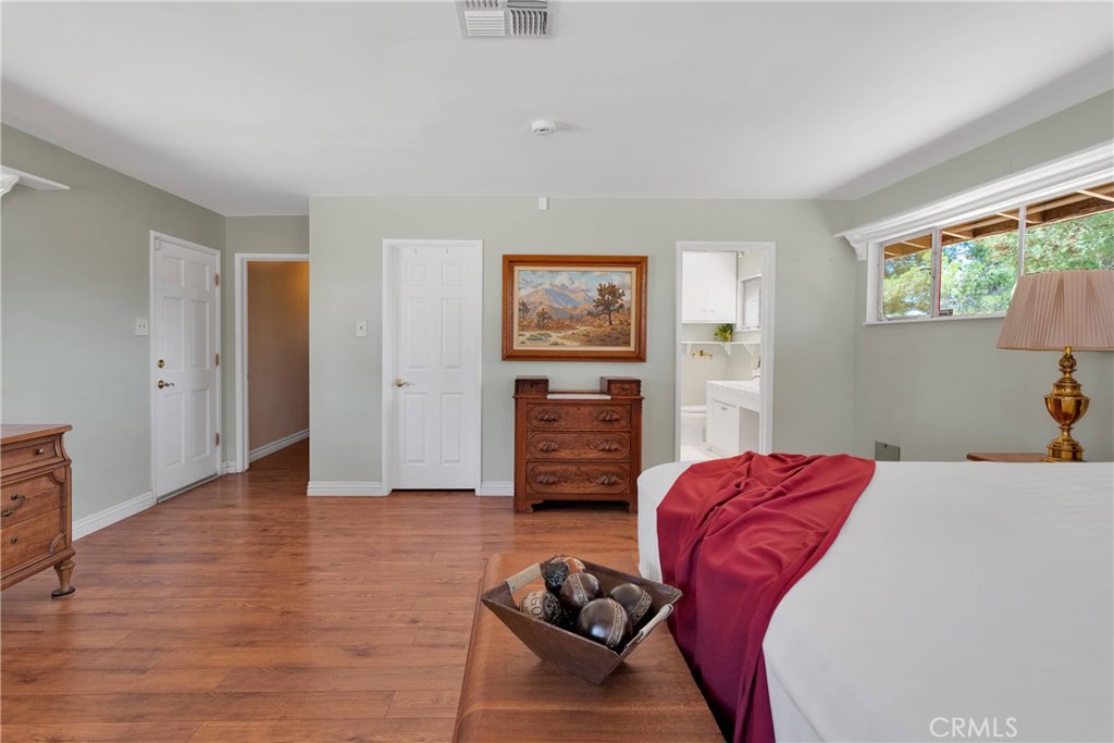 19955 Chickasaw Road Apple Valley, CA 92307 - Photo 24 of 60 a bedroom with a bed and wooden floor