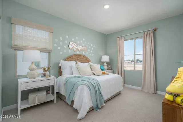 a spacious bedroom with a bed and a chandelier