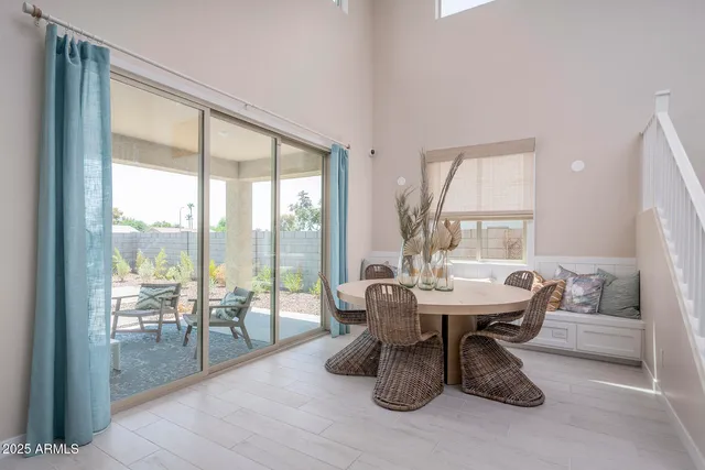 a dining room with furniture a chandelier and wooden floor