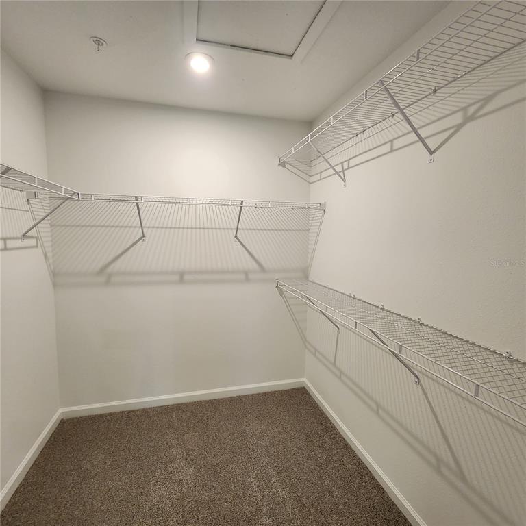 4232 Sadler Road Apopka, FL 32712 - Photo 14 of 31 a view of a room with racks on the wall