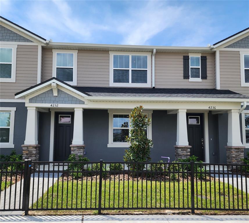 4232 Sadler Road Apopka, FL 32712 - Photo 2 of 31 a front view of a house with a garden