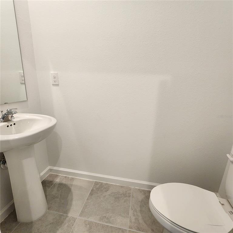 4232 Sadler Road Apopka, FL 32712 - Photo 7 of 31 a bathroom with a sink a toilet and mirror