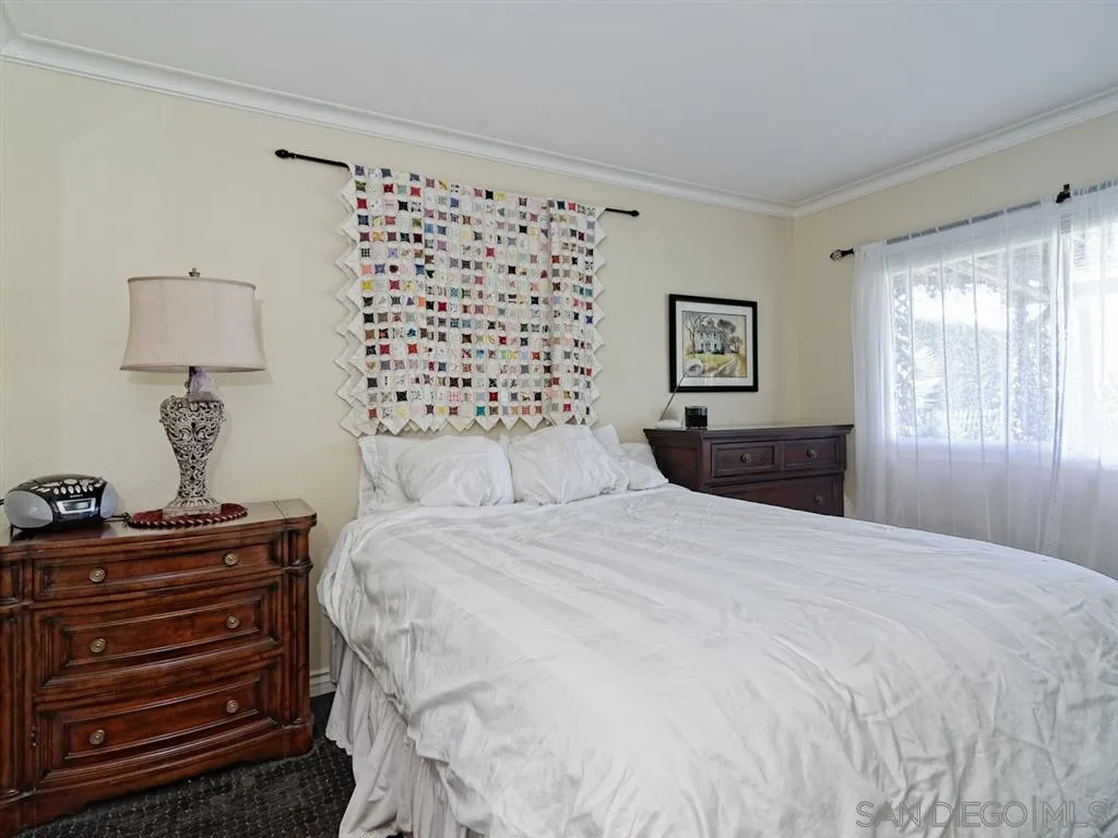 1718 West Knapp Drive Vista, CA 92083 - Photo 11 of 24 a bedroom with a bed and dresser with mirror