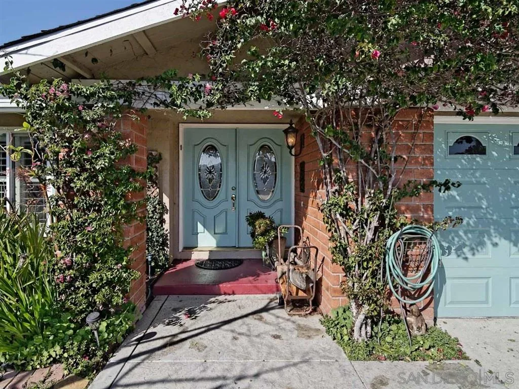 1718 West Knapp Drive Vista, CA 92083 - Photo 2 of 24 a front view of a house with garden