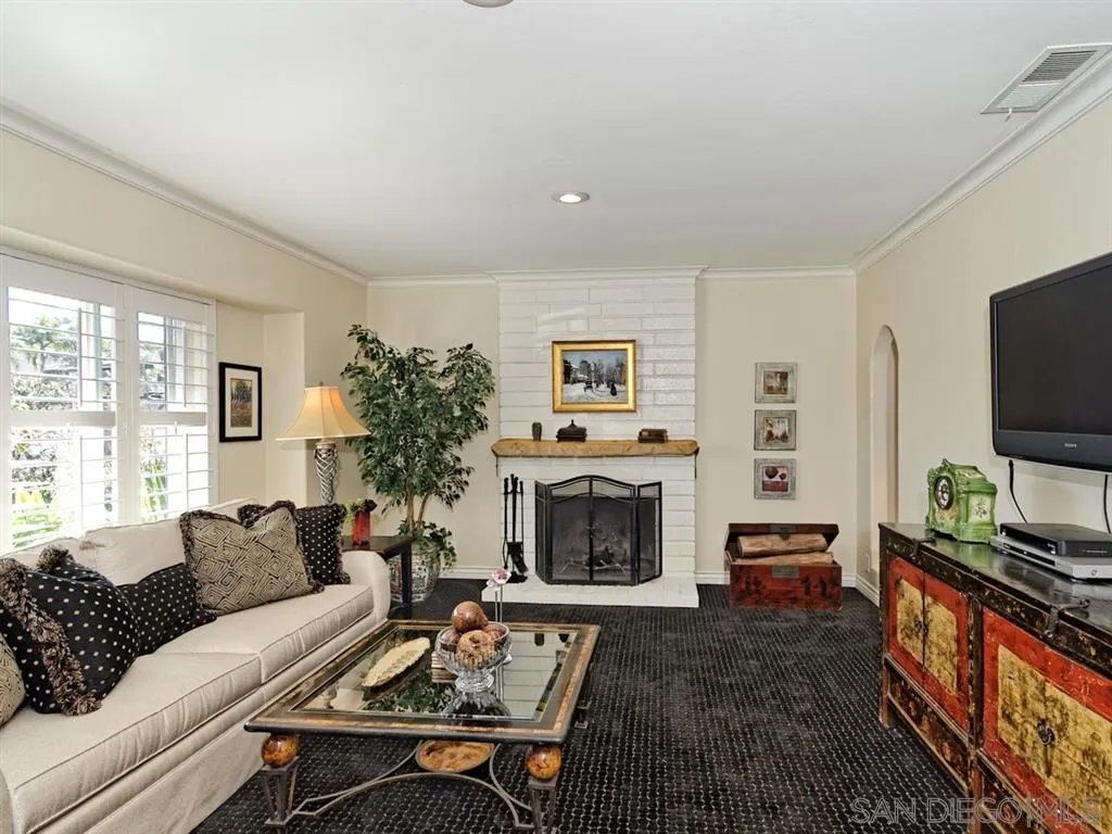 1718 West Knapp Drive Vista, CA 92083 - Photo 4 of 24 a living room with furniture a flat screen tv and a fireplace