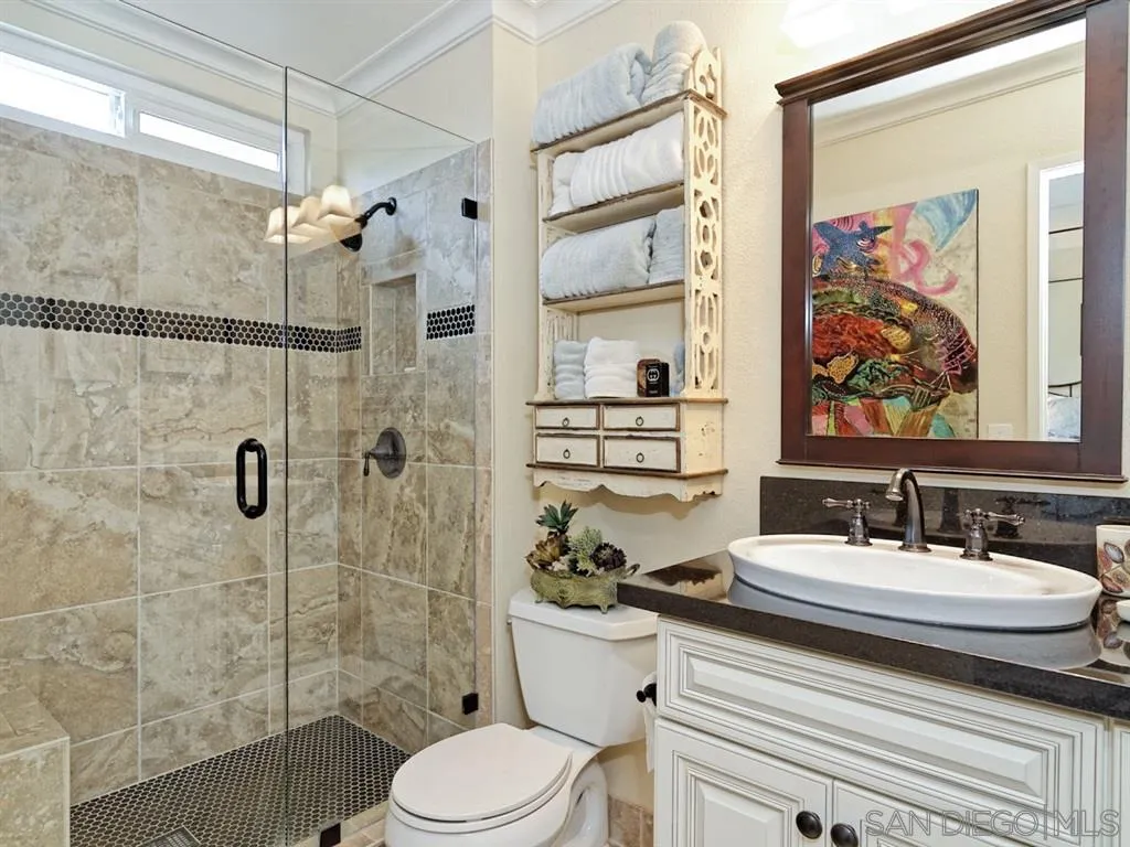 1718 West Knapp Drive Vista, CA 92083 - Photo 10 of 24 a bathroom with a sink toilet and shower