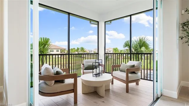 a balcony view with a large garden and furniture