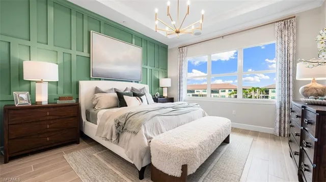 a bedroom with a bed table and window