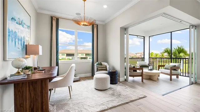 a living room with furniture and a floor to ceiling window