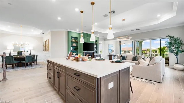 a large kitchen with kitchen island a island a stove a sink a dining table and chairs