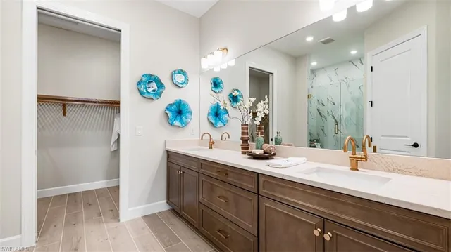 a bathroom with a sink double vanity and a mirror