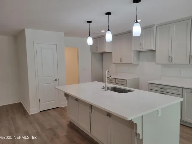 a kitchen that has a lot of cabinets in it
