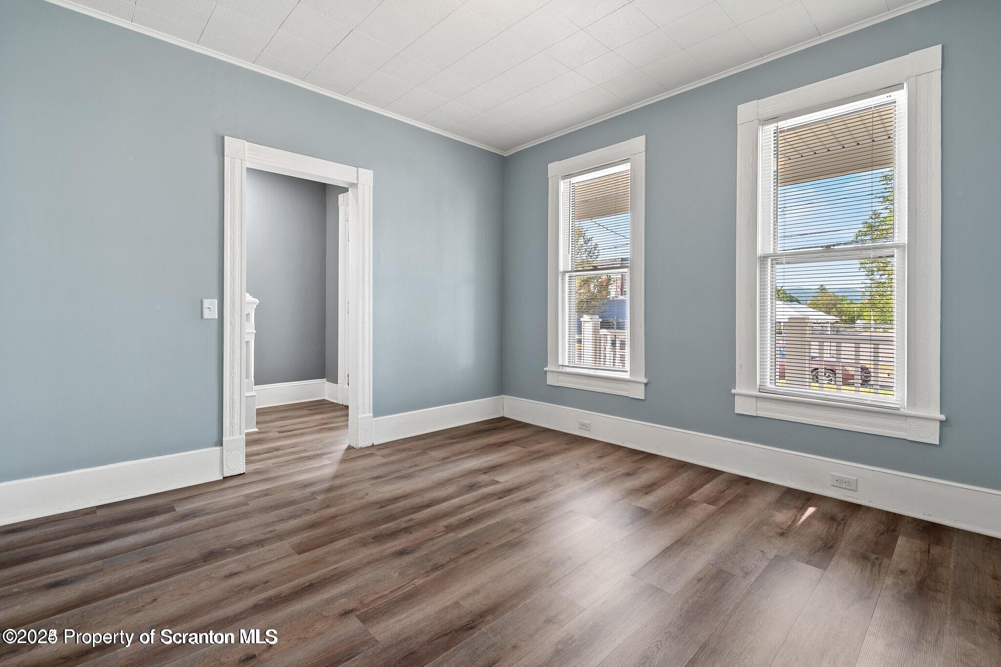 724 Electric Street Scranton, PA 18509 - Photo 4 of 17 a view of an empty room with wooden floor and a window