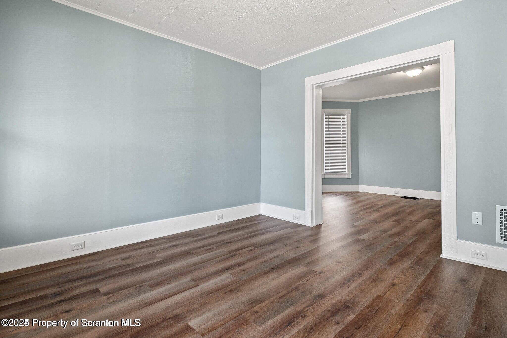 724 Electric Street Scranton, PA 18509 - Photo 8 of 17 a view of an empty room with wooden floor and closet