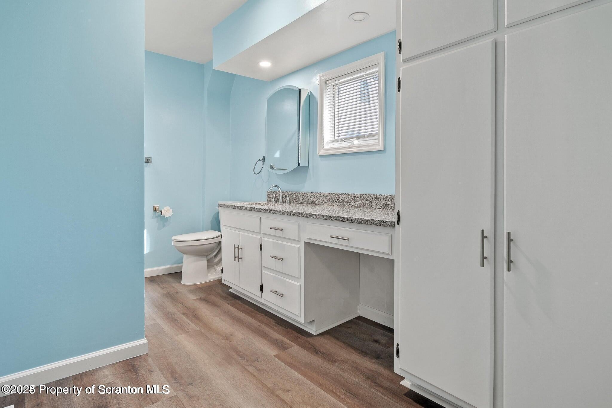 724 Electric Street Scranton, PA 18509 - Photo 10 of 17 a spacious bathroom with a toilet sink and mirror