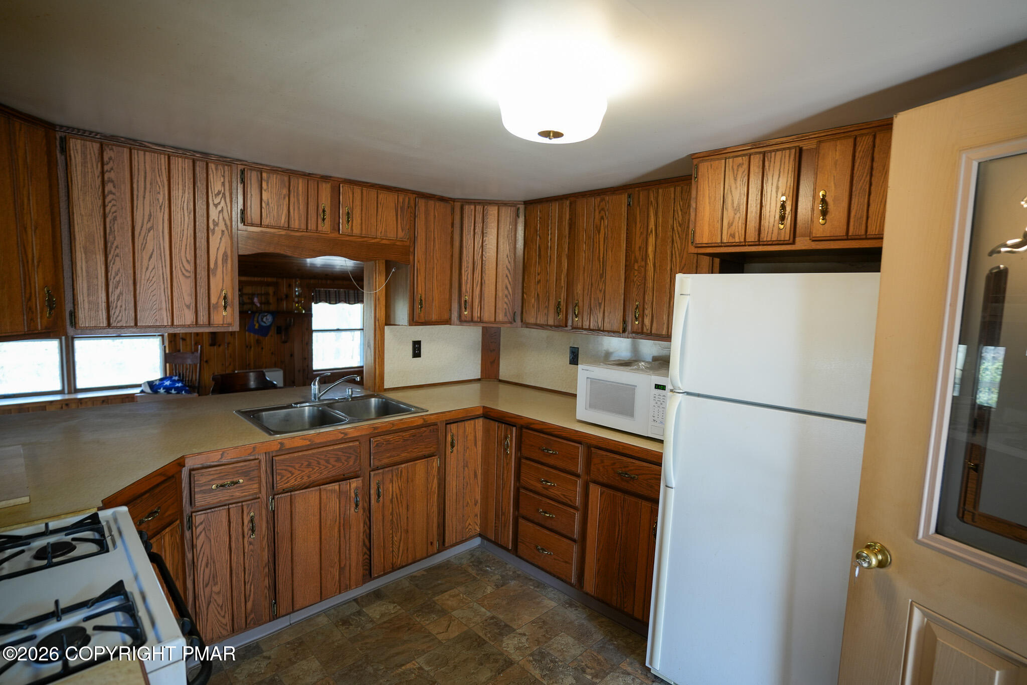 8245 Interchange Road Lehighton, PA 18235 - Photo 12 of 35 a kitchen with a sink a refrigerator and cabinets