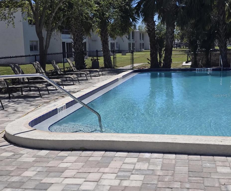 9911 Aquarius Drive, Unit 8 Port Richey, FL 34668 - Photo 16 of 25 a view of a yard with a slide