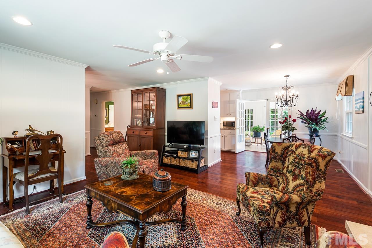 7612 Jock Road Bahama, NC 27503 - Photo 11 of 53 a living room with furniture and a flat screen tv with wooden floor