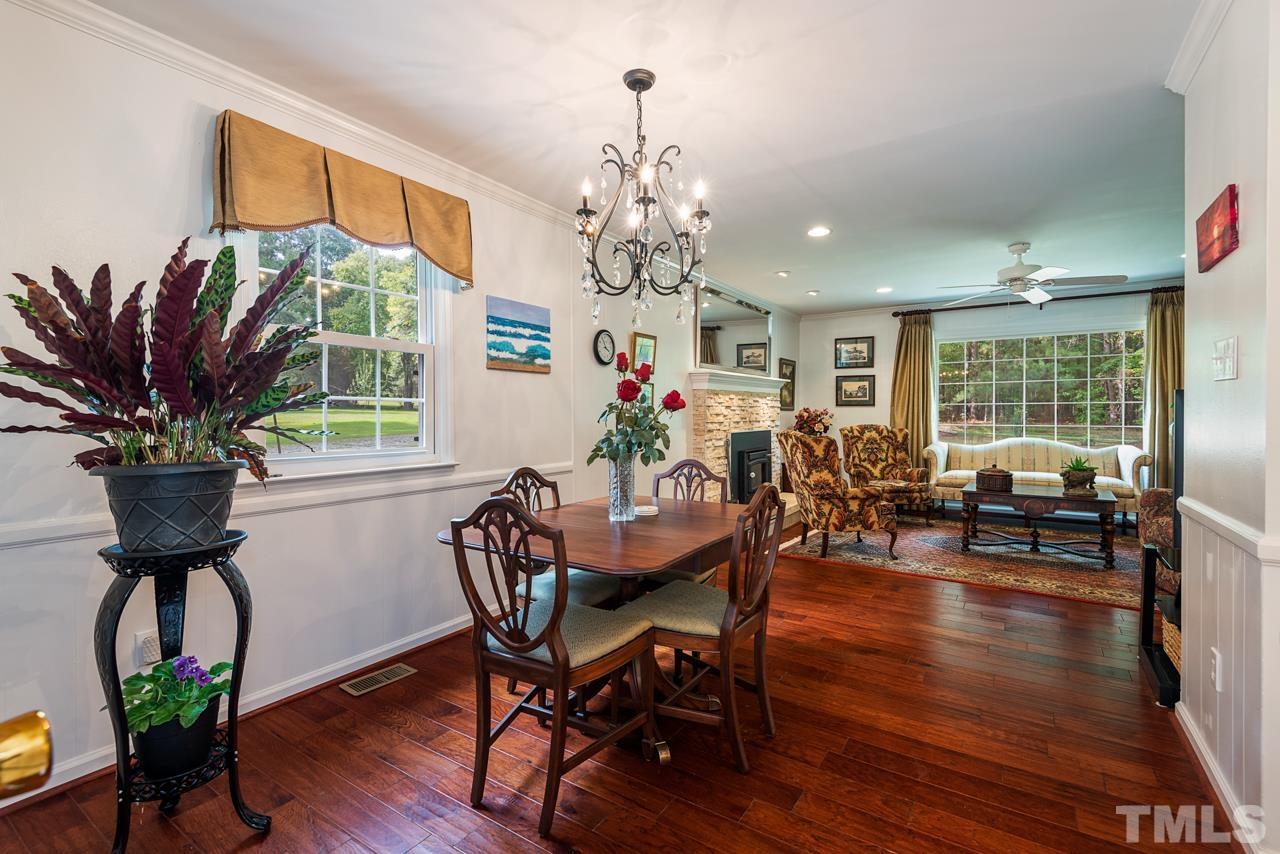 7612 Jock Road Bahama, NC 27503 - Photo 20 of 53 a view of a dining room with furniture a chandelier and wooden floor