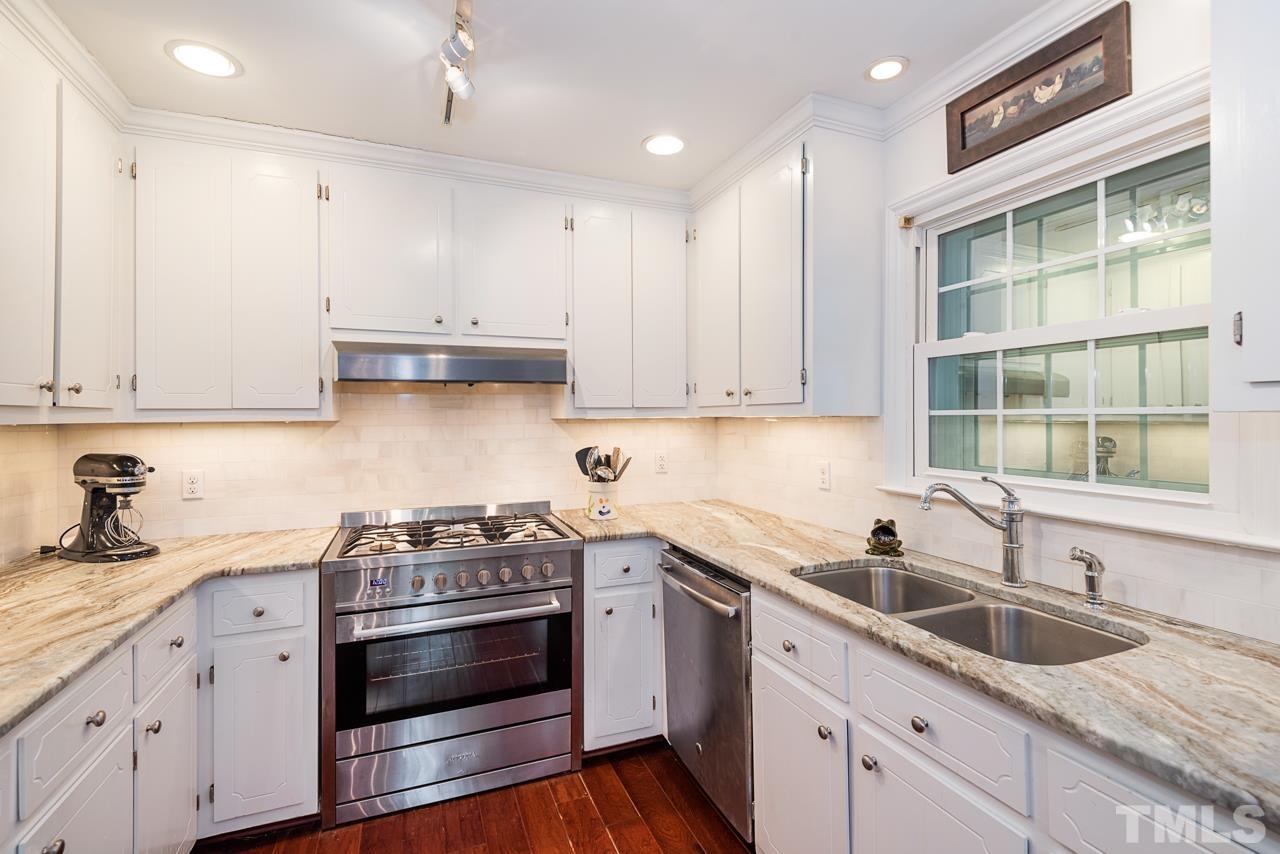7612 Jock Road Bahama, NC 27503 - Photo 21 of 53 a kitchen with granite countertop a sink stainless steel appliances and cabinets