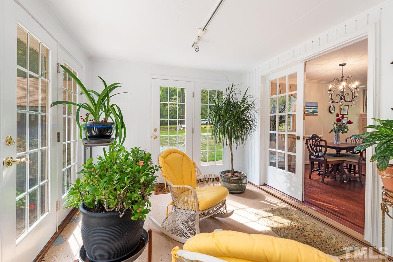 7612 Jock Road Bahama, NC 27503 - Photo 26 of 53 a living room filled with furniture and a potted plant