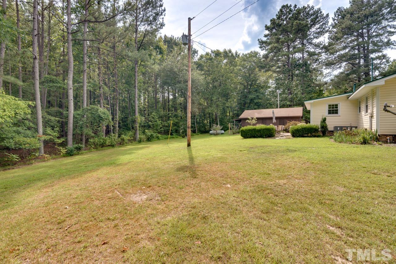 7612 Jock Road Bahama, NC 27503 - Photo 42 of 53 a view of a house with backyard and trees