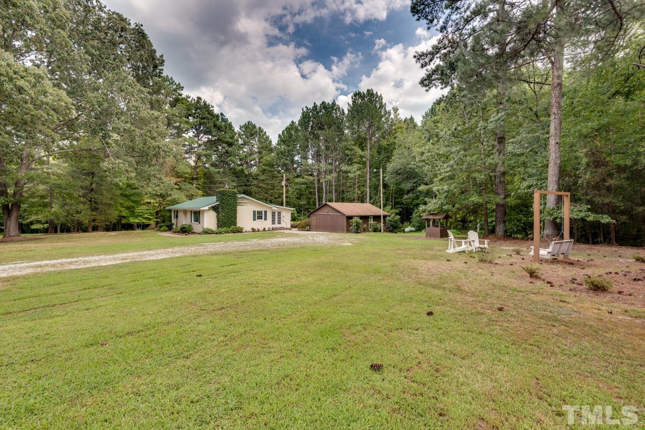 7612 Jock Road Bahama, NC 27503 - Photo 48 of 53 a front view of a house with a yard and trees