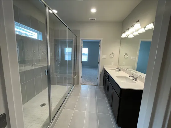 a bathroom with a sink a light fixture and a mirror