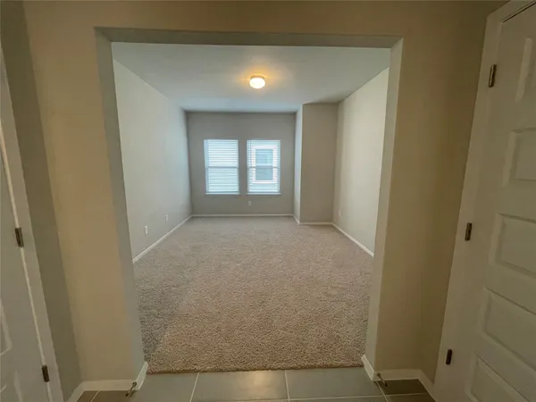 a view of hallway with window and stairs