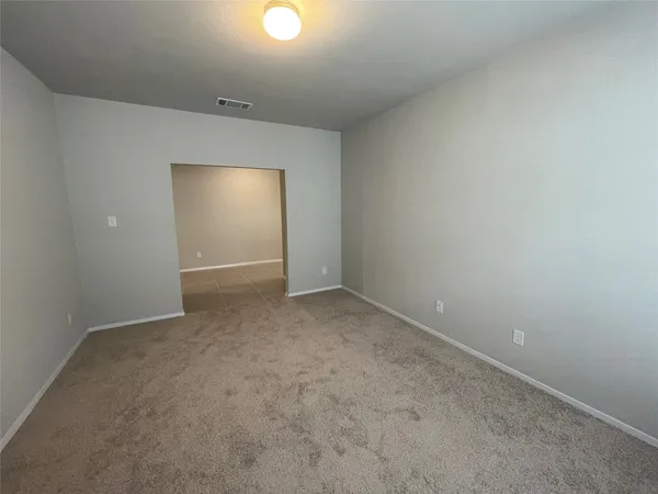 an empty room with a empty space and windows