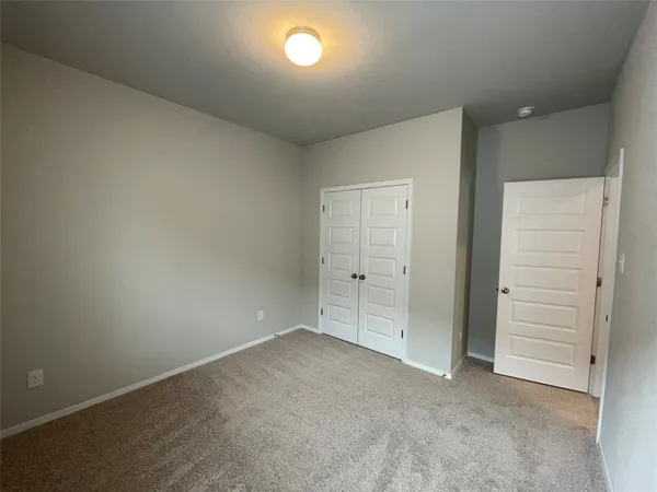 an empty room with closet area