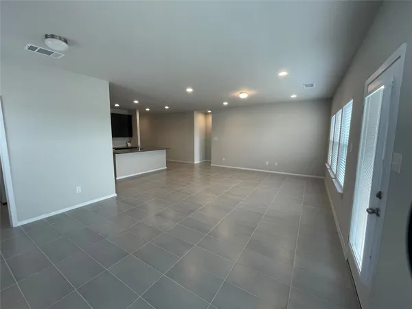 an empty room with a fireplace and windows